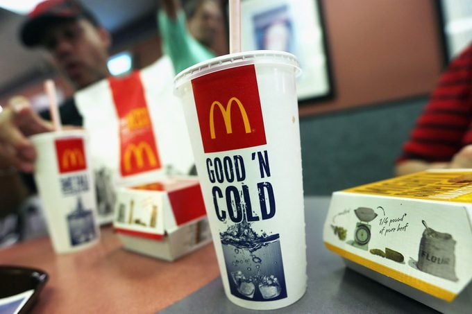 A Customer eats a combo meal and a soda at a McDonalds in New York City