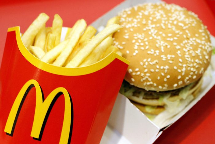 A Mcdonald's Big Mac And Fries Combo Meal Pictured on a Red Background