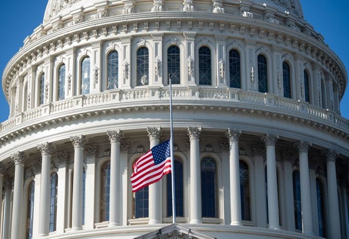 The Outside of the US Capitol with a US Fla Flying at Half Mast on the Flag Pole