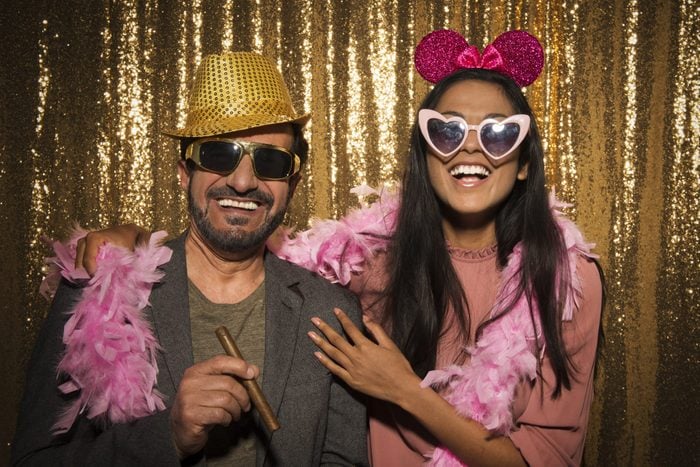 Portrait of mature man and young woman enjoying party