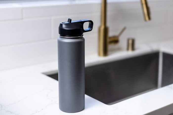 Grey water bottle on sink counter
