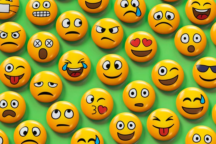 various emojis with different facial expressions on a green background