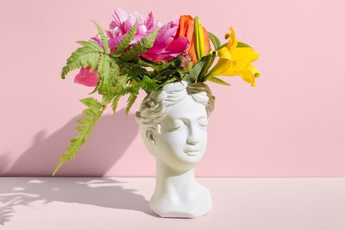 Head Sculpture With Flowers On pink Background. Creative Positive Thinking Concept. Minimal Mental Health Awareness Month. Psychology, Emotional Wellness, Progress, Flowering, Work On Yourself Idea