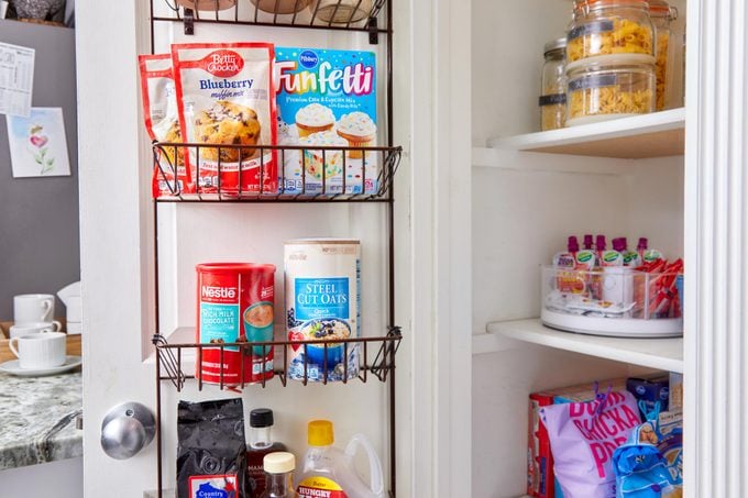 food organized in the side of the door of a kitchen pantry