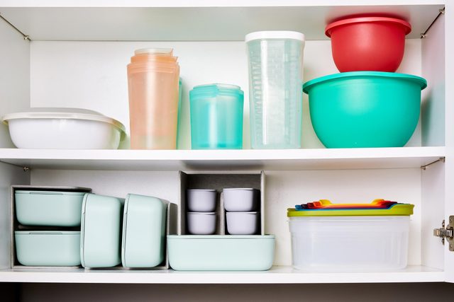 Food storage containers in an organized kitchen cabinet