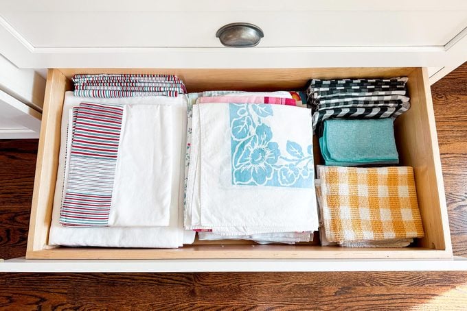 towels and linens in an organized kitchen drawer