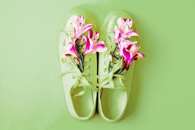 green shoes with pink flowers on green background