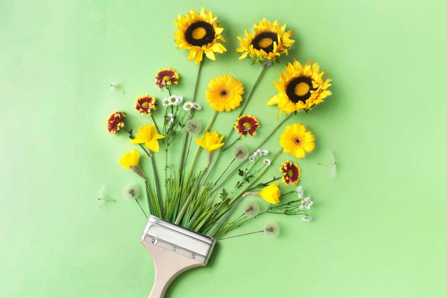 paint brush with flowers on green background