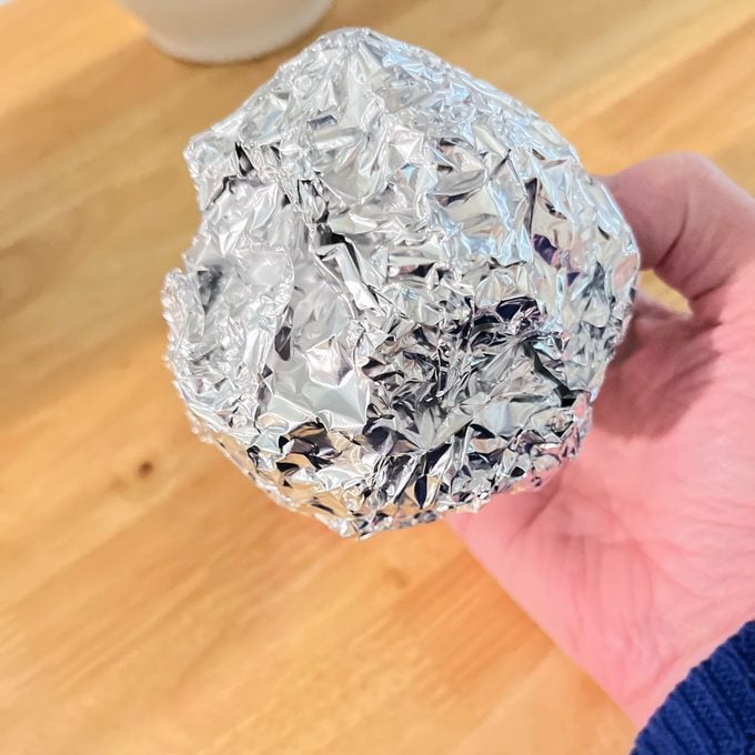 Squeeze the foil to make a ball