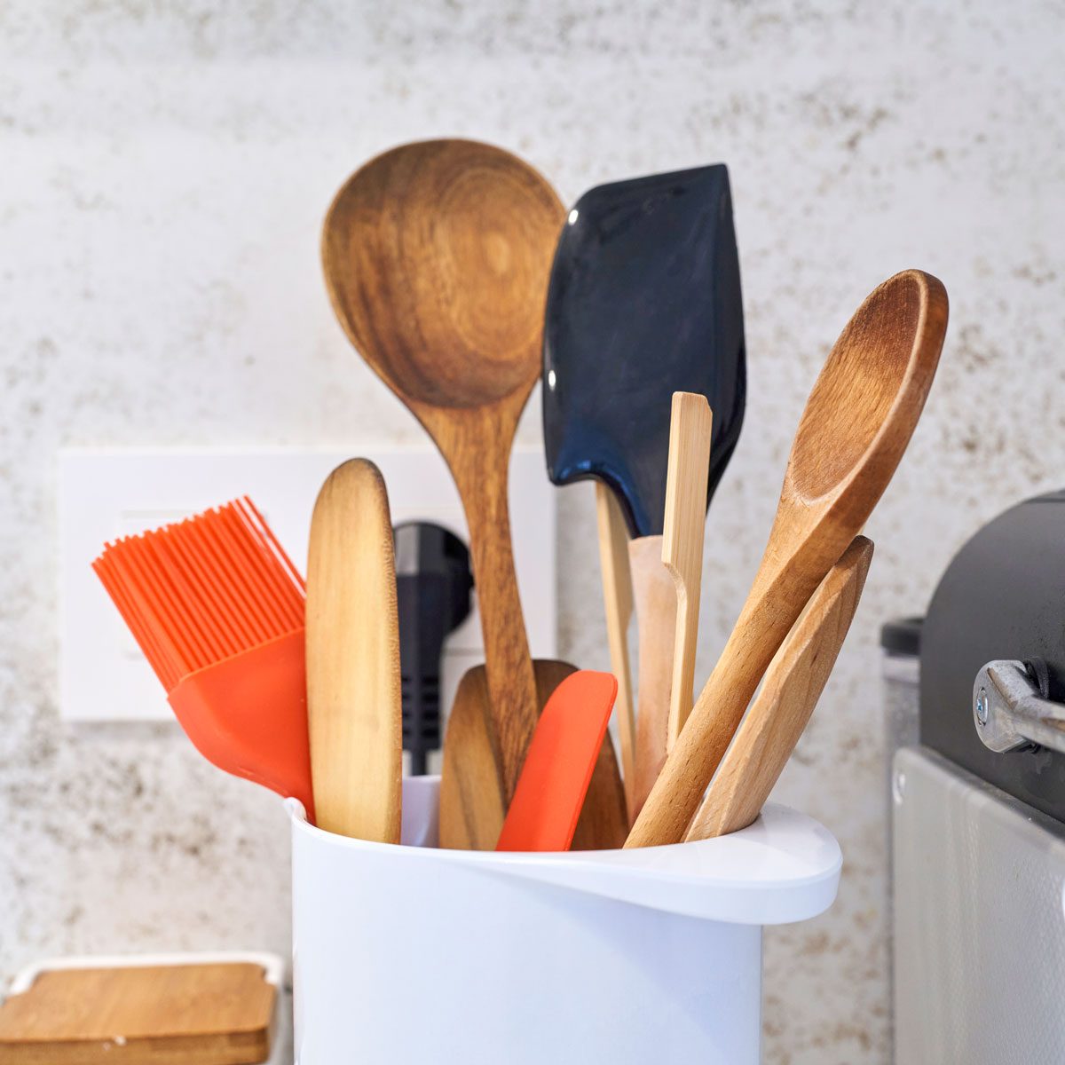Close Up Of Different Kitchen Utensils Inside White Container