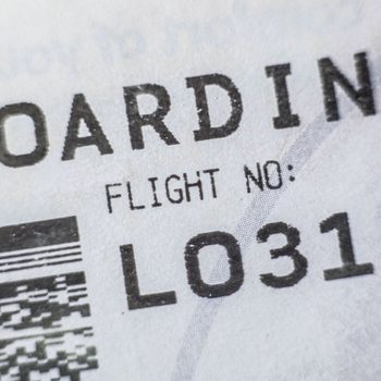 Boarding Pass Displaying Bar Code and Flight Number Seen in Airport in Warsaw