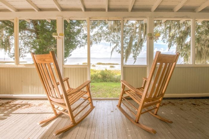 Pair Of Old Rocking Chairs On A Porch Overlooking An Inlet At Sapelo Island, Georgia