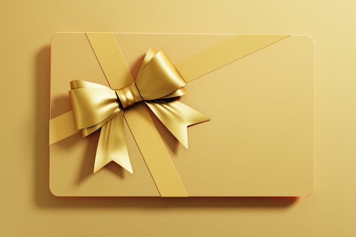 gold Gift Card with tied Bow on gold background