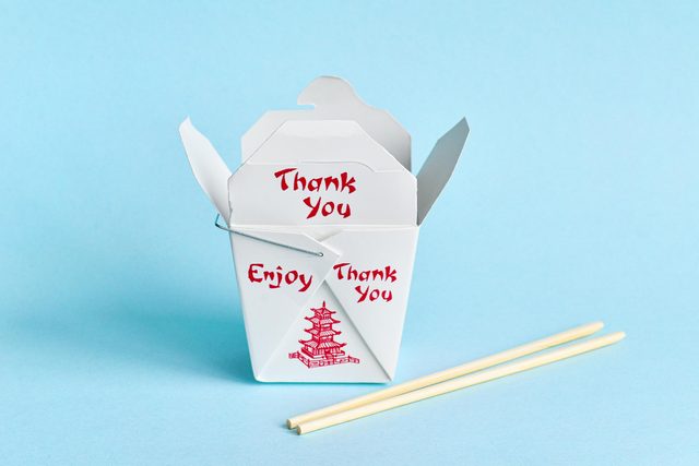 take out container with chopsticks on a blue background