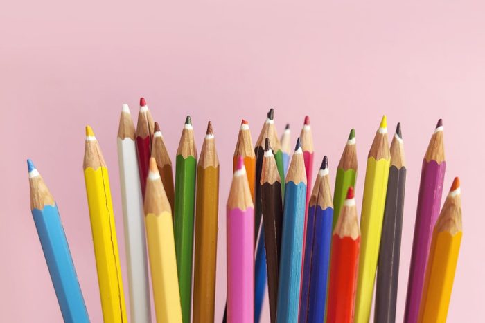 Colorful pencils with copy space on pink background