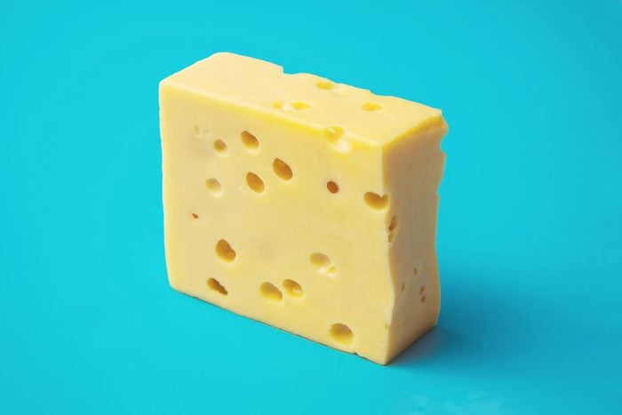 swiss cheese block with holes on a teal background