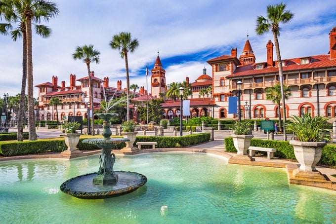 The Town Square in St. Augustine Florida on a bright sunny day with fountains, palm trees and terracotta roof buildings