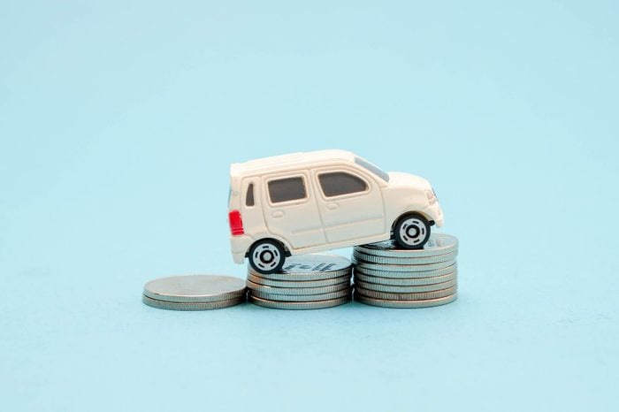 save money for investment concept Toy car and stack of coins