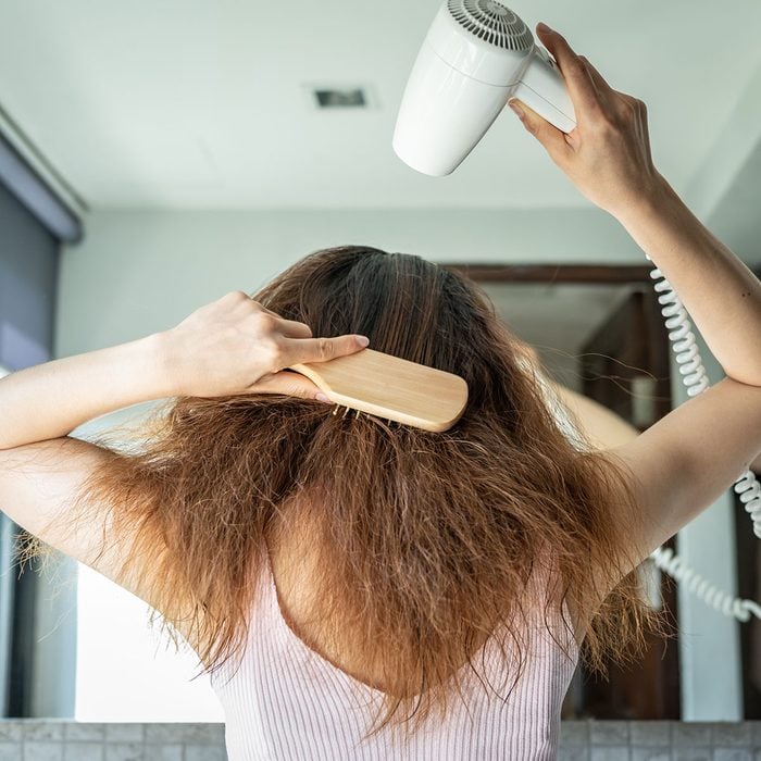 Girl Blow Drying and Brushing her Hair