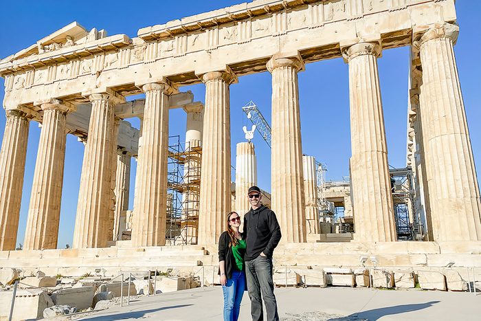 A Couple Standing In Front Of Parthenon Athens Greece