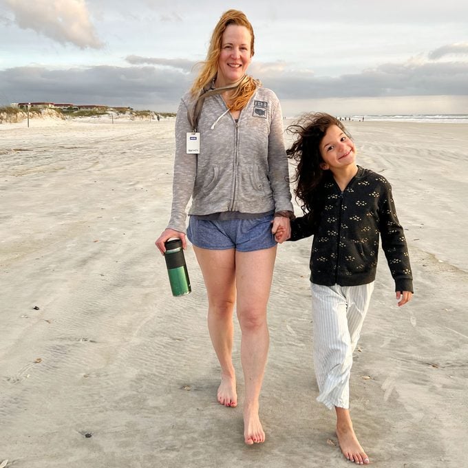 author, Anne Fritz, walking on the beach with her daughter in st. augustine, florida