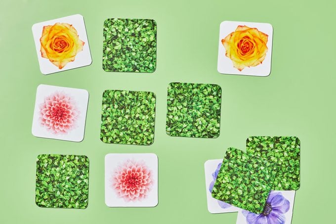 memory tiles game with flowers and greenery on green background