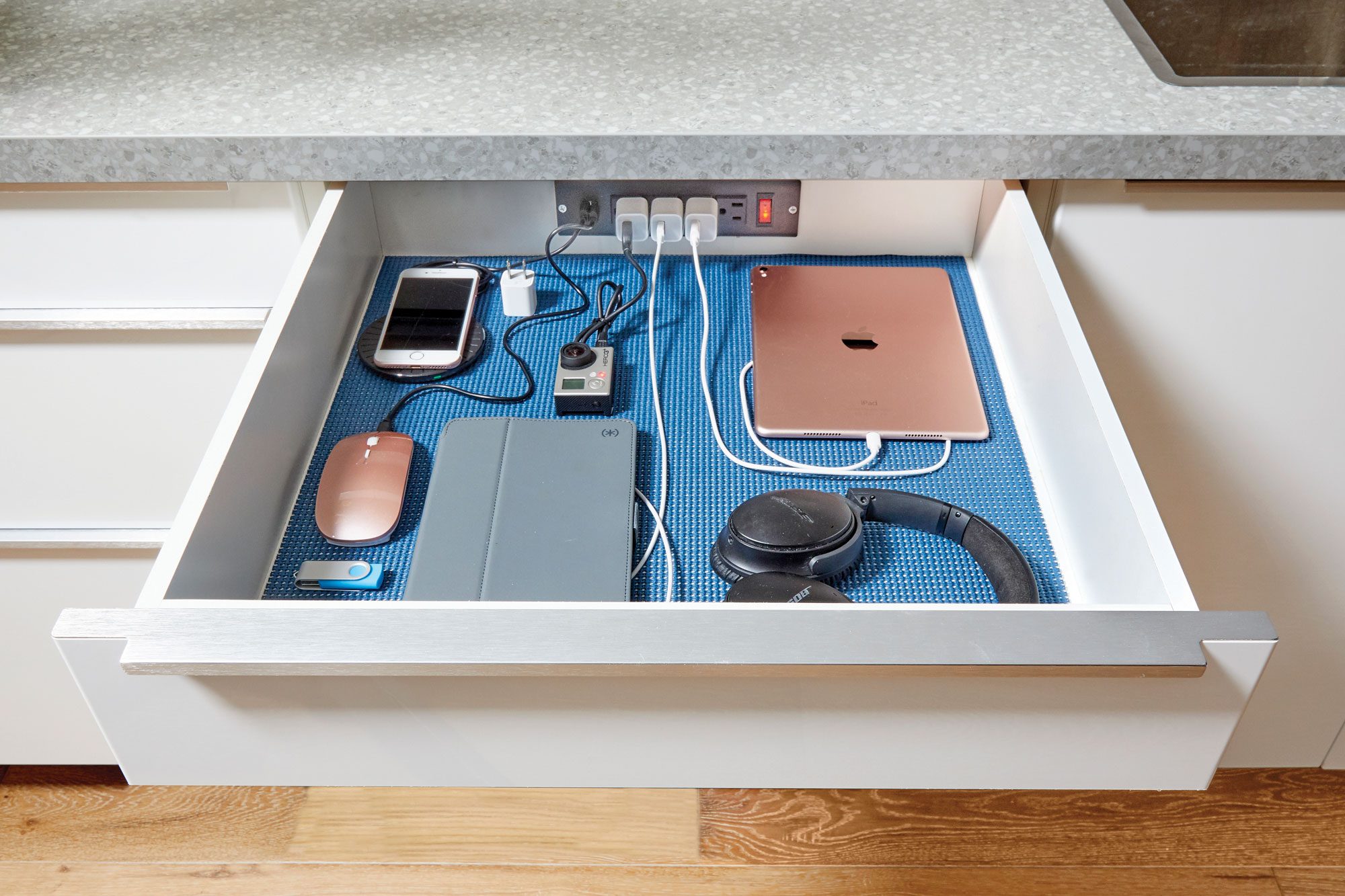 outlet built into a kitchen drawer to manage cords plugged in devices
