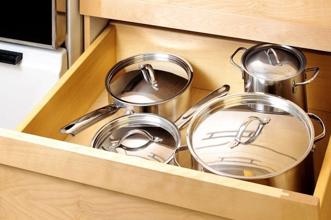 pots and pans organized in a deep kitchen cabinet drawer