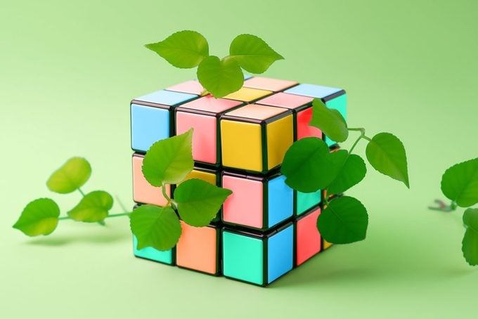 rubik's cube with vines on green background