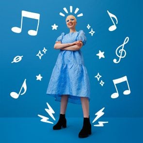 albino woman standing confidently with arms crossed on a blue background, stars, lightning bolts, music note doodles
