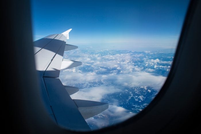 Snowcapped mountains seen through airplane window