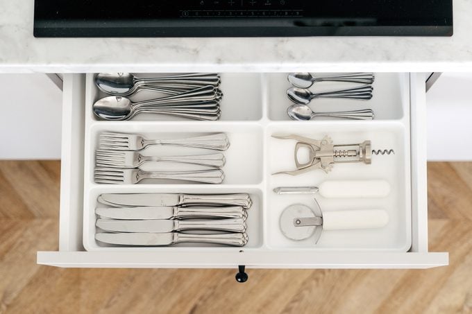 Open drawer with cutlery in a modern kitchen