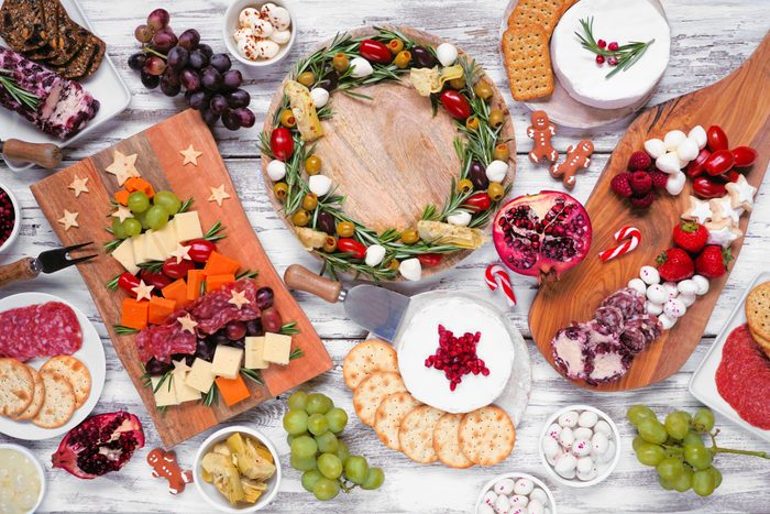 Christmas charcuterie table scene over a white wood background