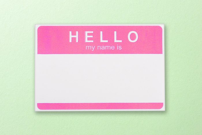 pink "hellow my name is" name tag on a green background