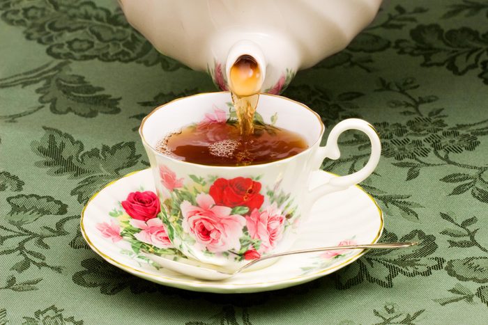 victorian high tea pot being poured into a tea cup for christmas
