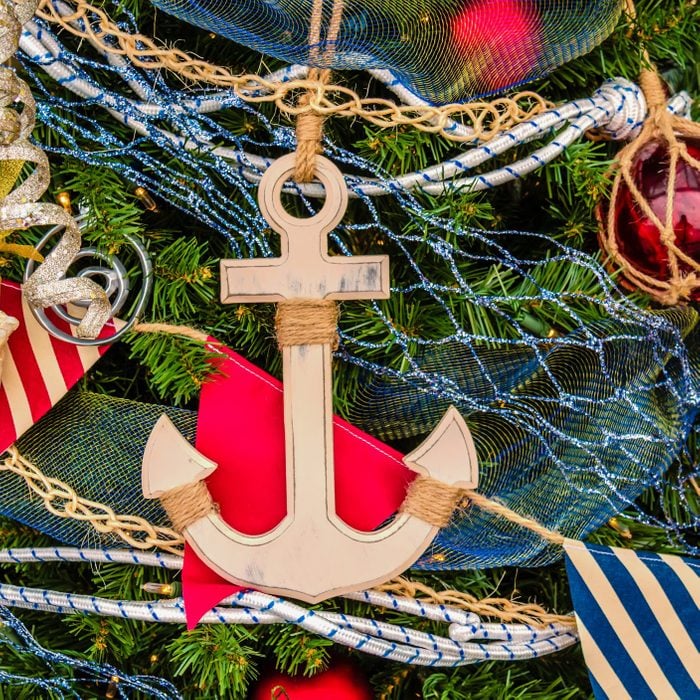 Christmas toys, an anchor, a star, balls and flags on a Christmas tree
