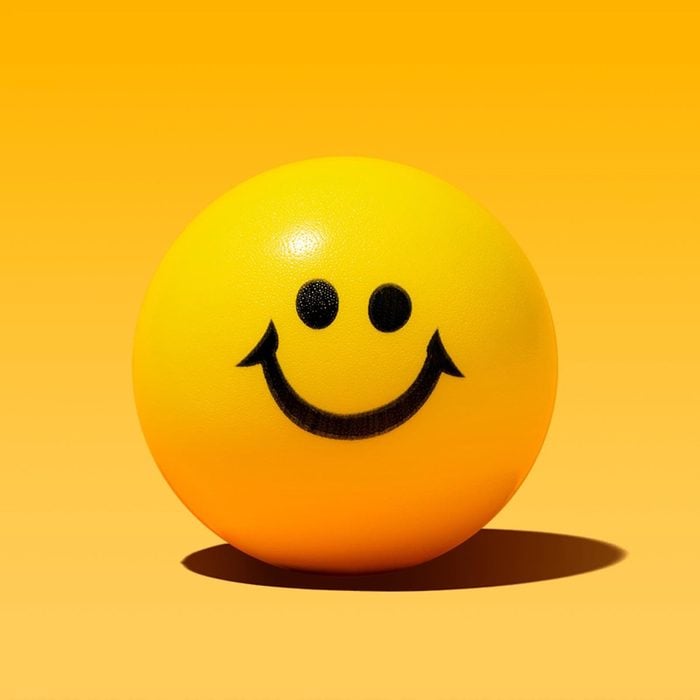 round smiley face on yellow background
