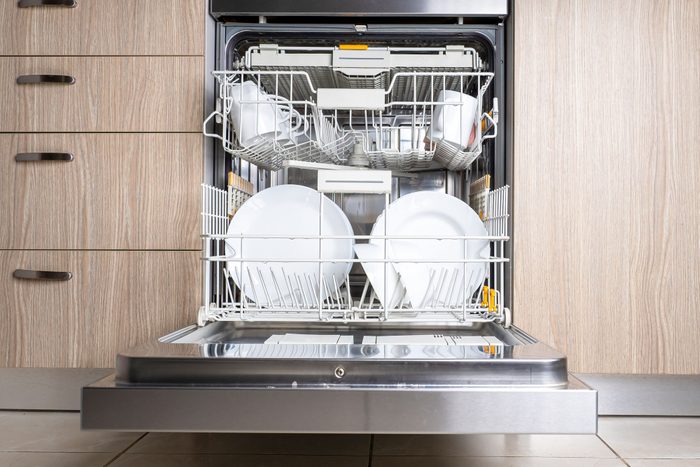 Plates And Dishes In The Built In Dishwasher In Kitchen