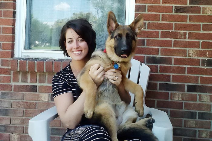 woman and a rehomed german shepherd dog