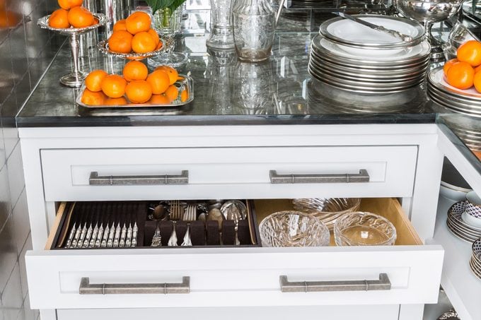 kitchen with utensil drawer and plates for hosting a party