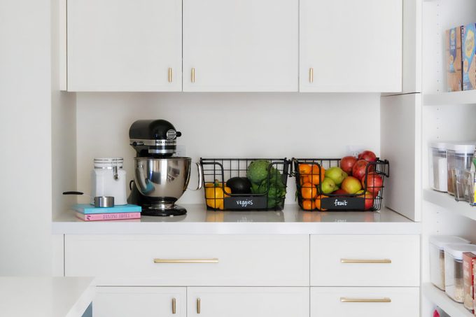 modern kitchen with fruit stored in black metal baskets