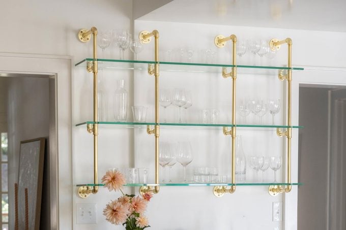 glass shelf in kitchen displaying glasses