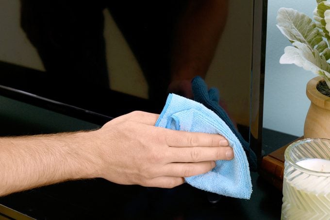cleaning flat screen tv with blue cloth