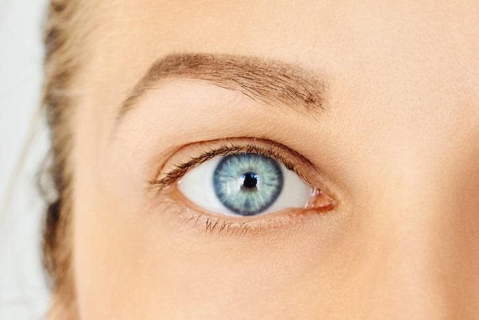 Close-up of female blue eye without make-up