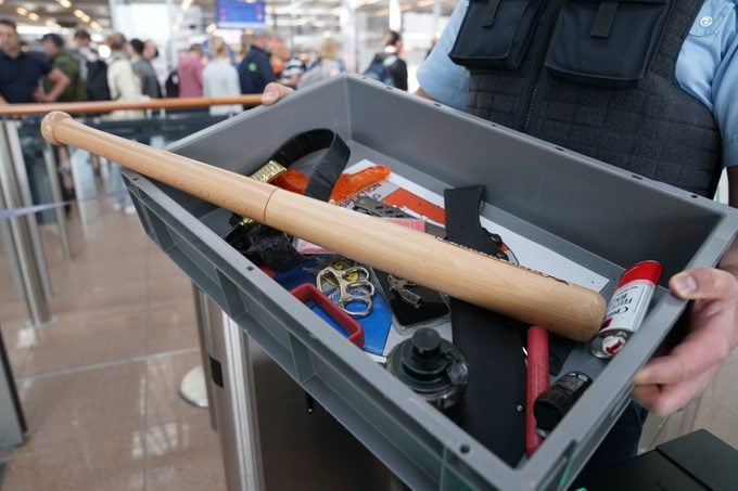 items confiscated by TSA agents in a bin being carried by a TSA agent at an airport in germany