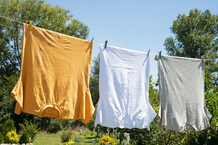 three t-shirts air drying outside