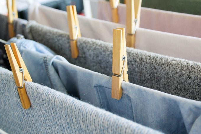 close up of clothes pin and laundry drying on a rack
