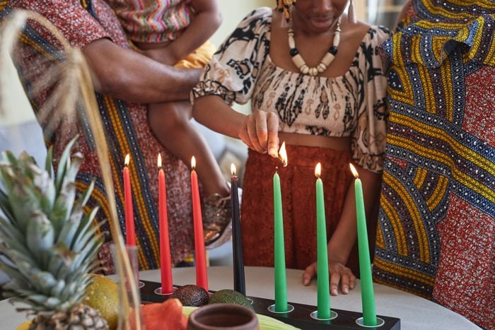African family of four lighting candles