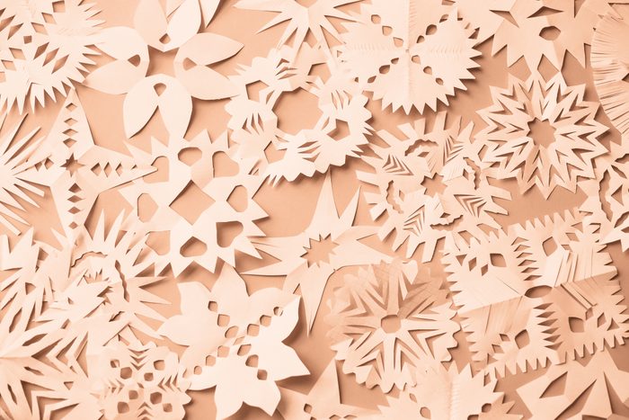 Background of Christmas origami in Peach Fuzz colour