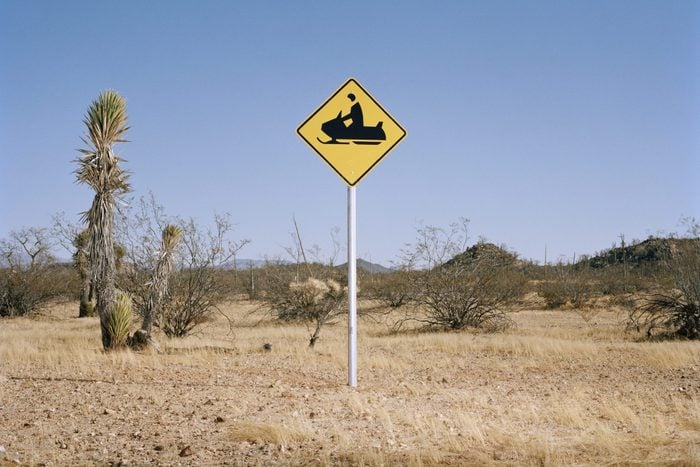 Snowmobile warning sign in desert